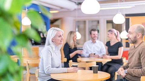 employees having a coffee and laughing