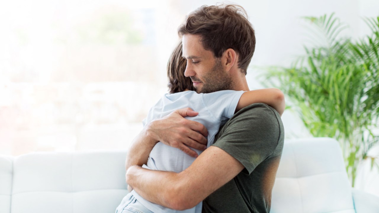 Dad hugging son