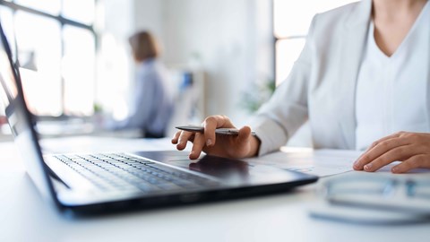 Woman's hand typing on a laptop